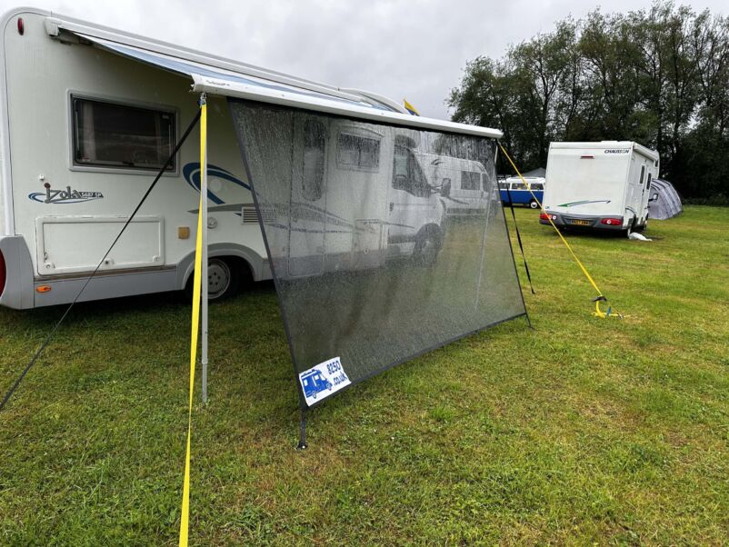 Awning shade protecting a motorhome in wet weather