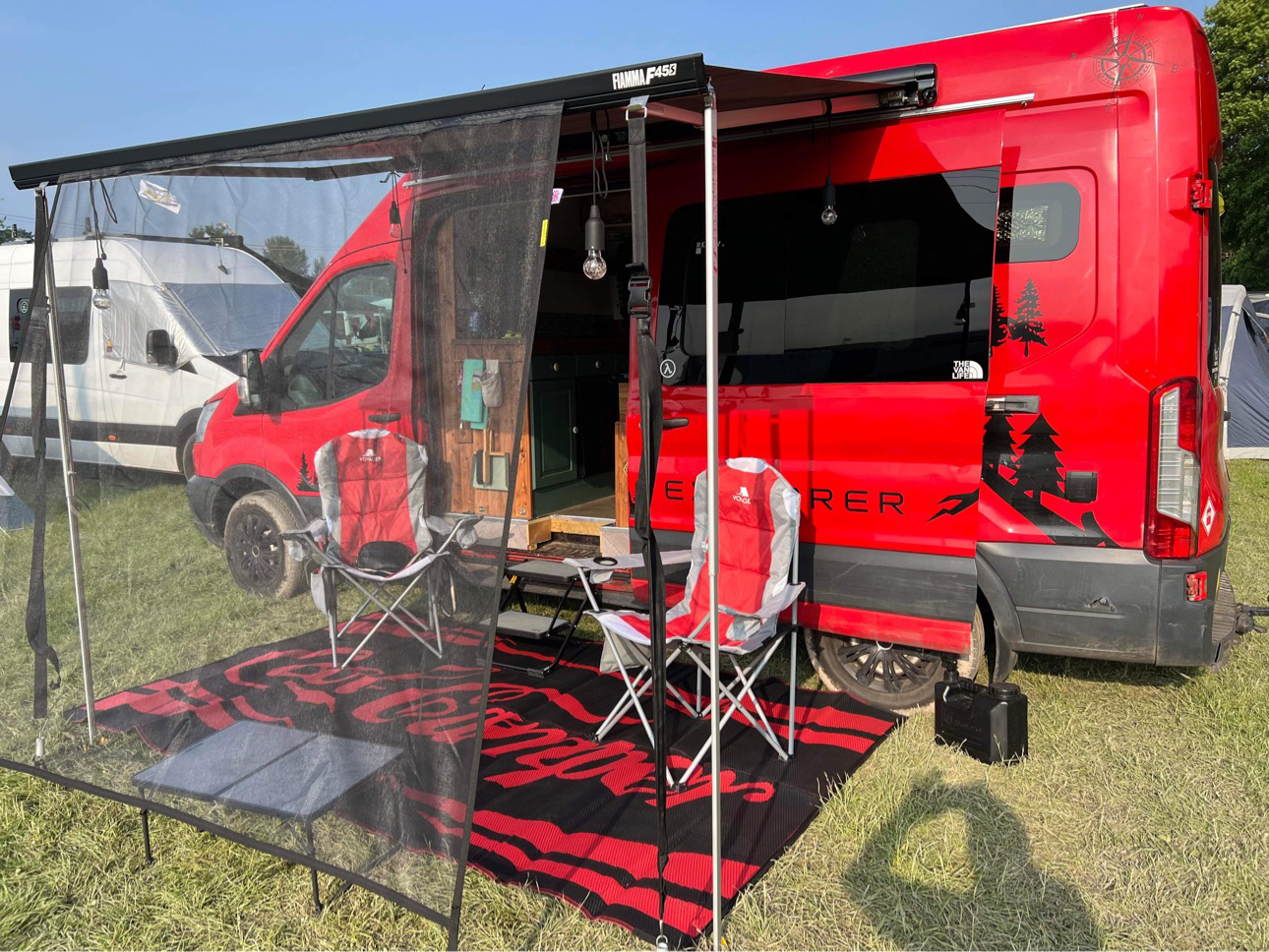 Two metre awning shade fitted to a red campervan